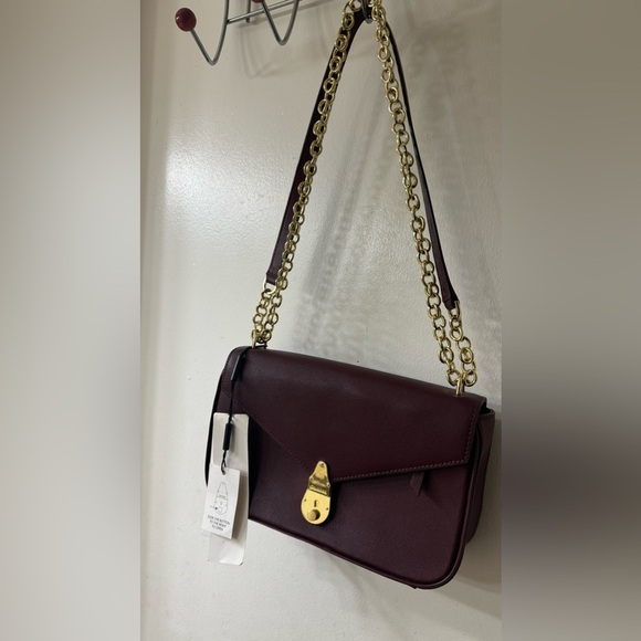 Calvin Klein women’s lock leather shoulder oxblood/gold...